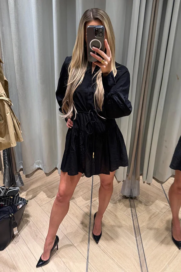 Beautiful blonde companion in London modelling black dress and heels.